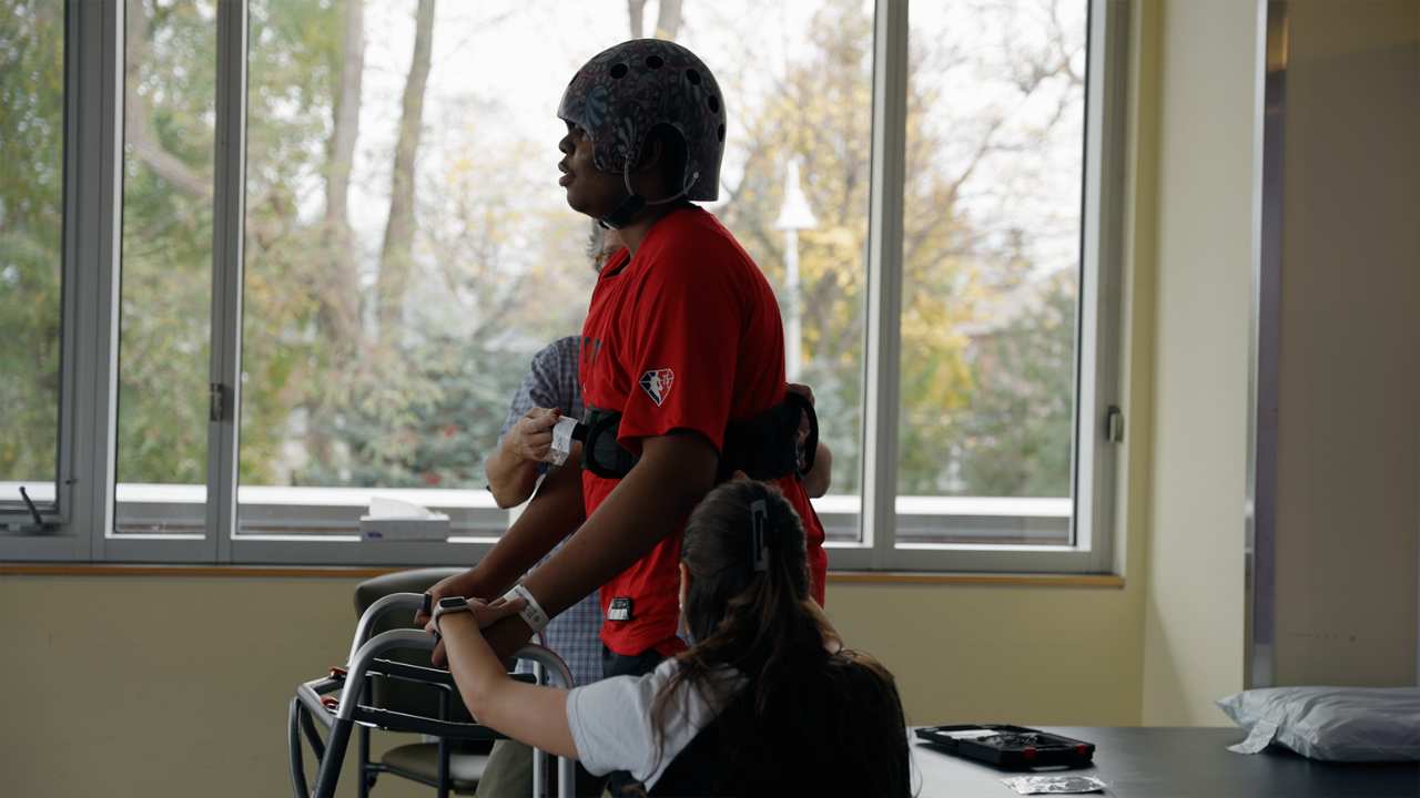 a man being assisted as he walks